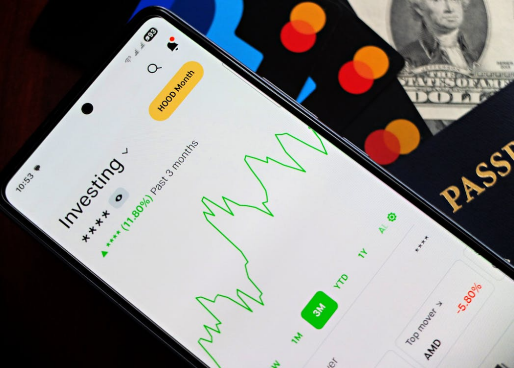 investment app and bank cards illustrating small investments for wealth building through mobile portfolio tracking