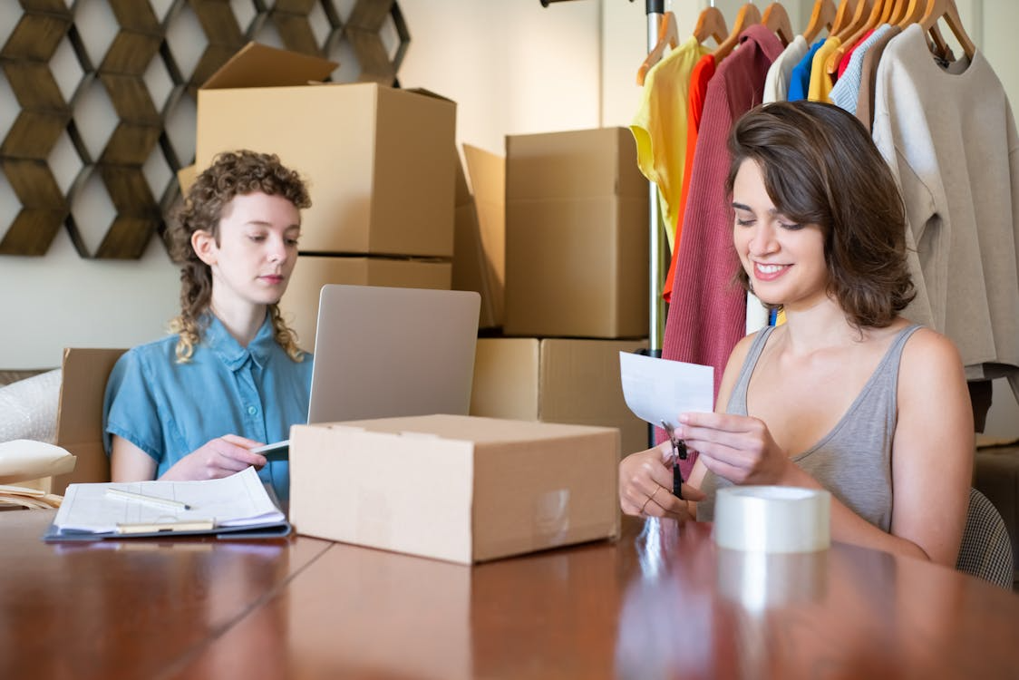 Small business owners packing orders and managing products to scale a small business