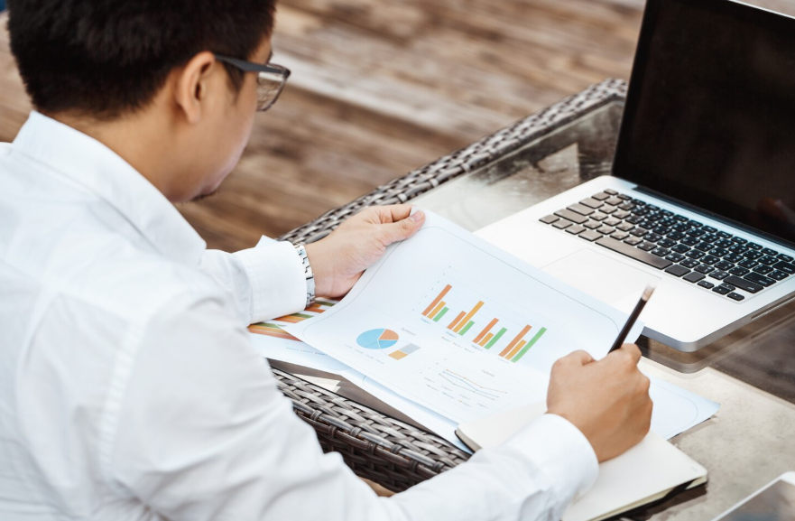 Investor reviewing charts and portfolio data to illustrate a consistent investing strategy